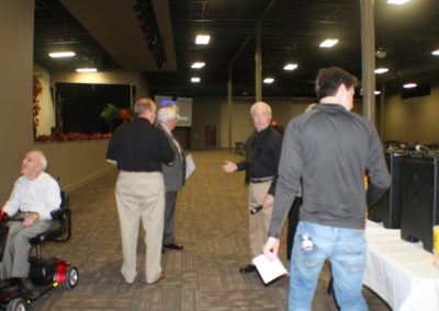A group of people standing around in an indoor area.