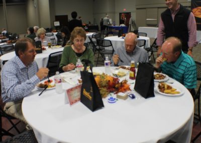 A group of people sitting at a table eating food.